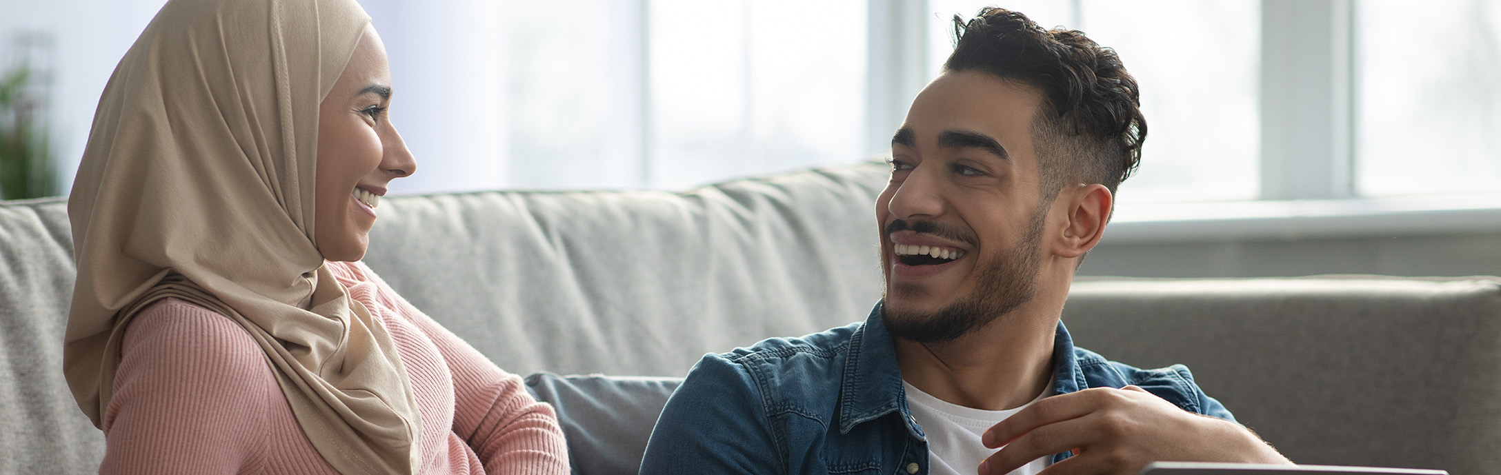 Man and woman sitting laughing