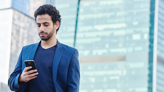 Man looking down at his mobile phone. 