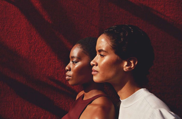 women together facing sun