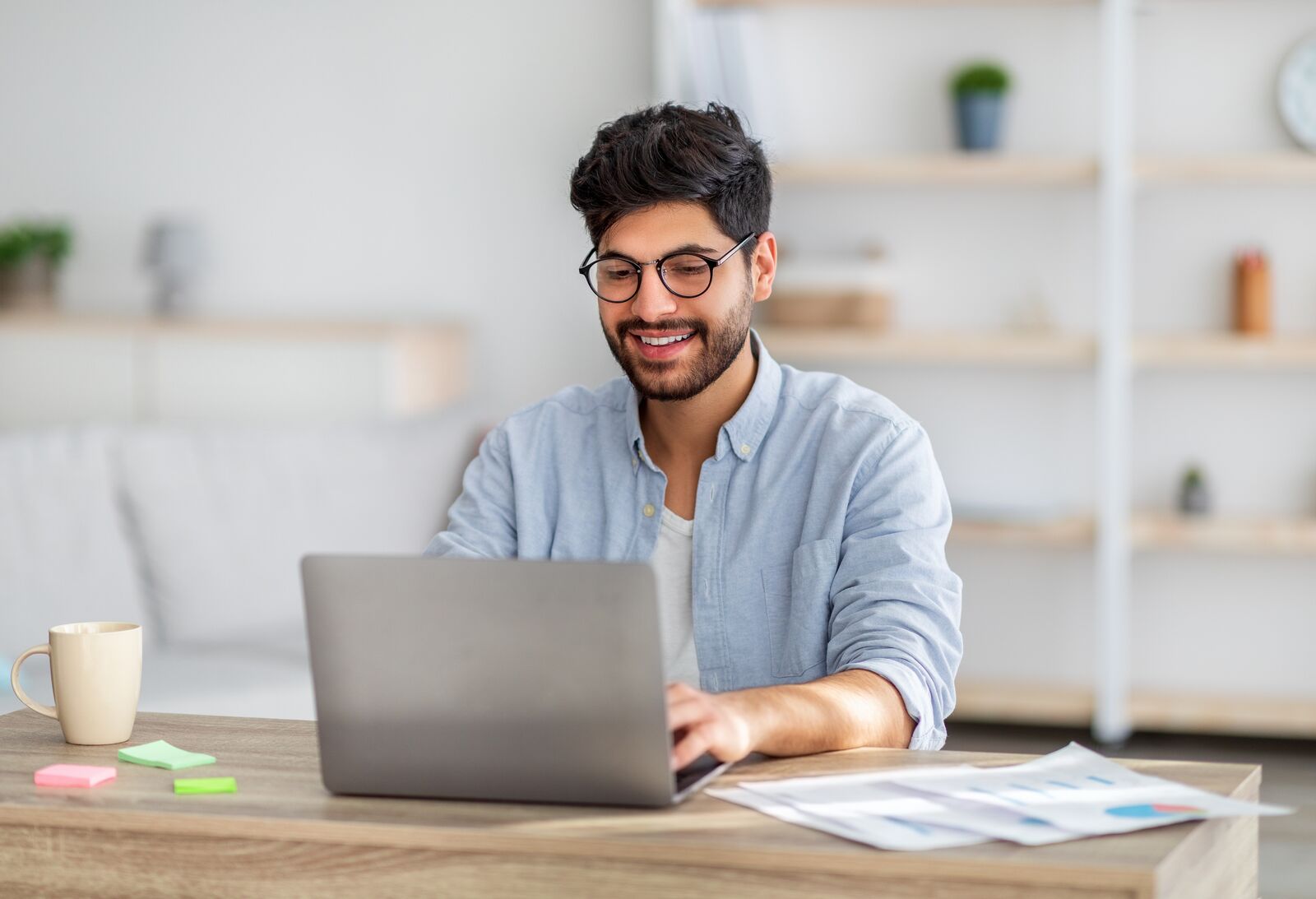 Bupa LifeWorks. Image shows a man in glasses working on a laptop.